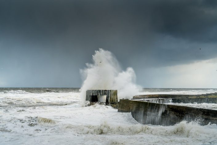 Waves over Seahouses pier